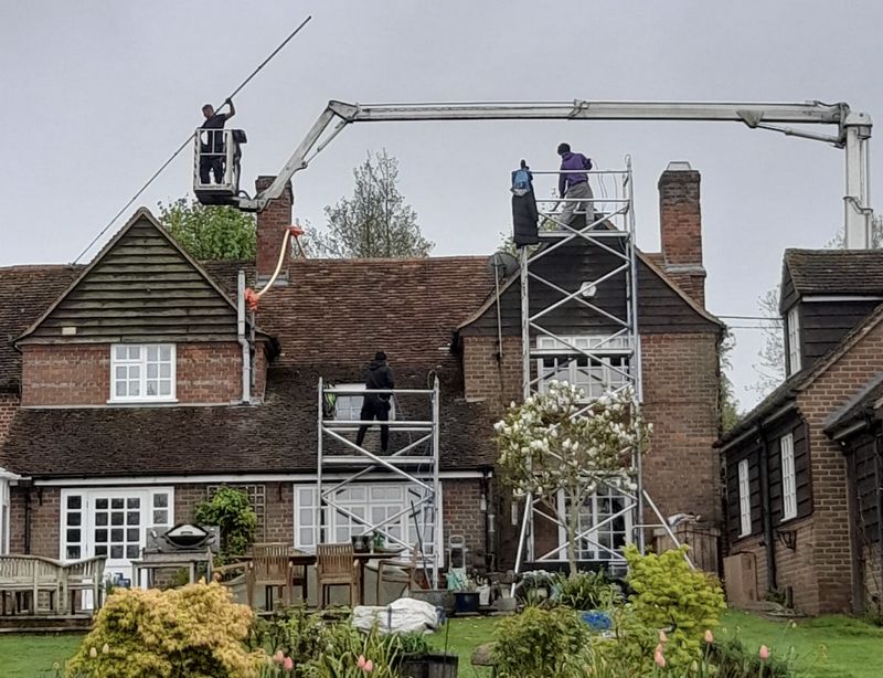 The Roof Moss Cleaners using cherry picker and scaffolding to clean roof safely and professionally in Biggleswade, Bedfordshire